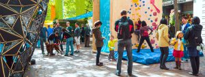People interacting with outdoor climbing wall